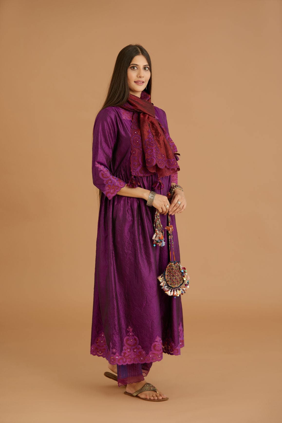 Purple hand crushed silk kurta set with wavy empire waistline and gathers, with silk and organza cutwork embroidery, highlighted with hand attached mirrors.