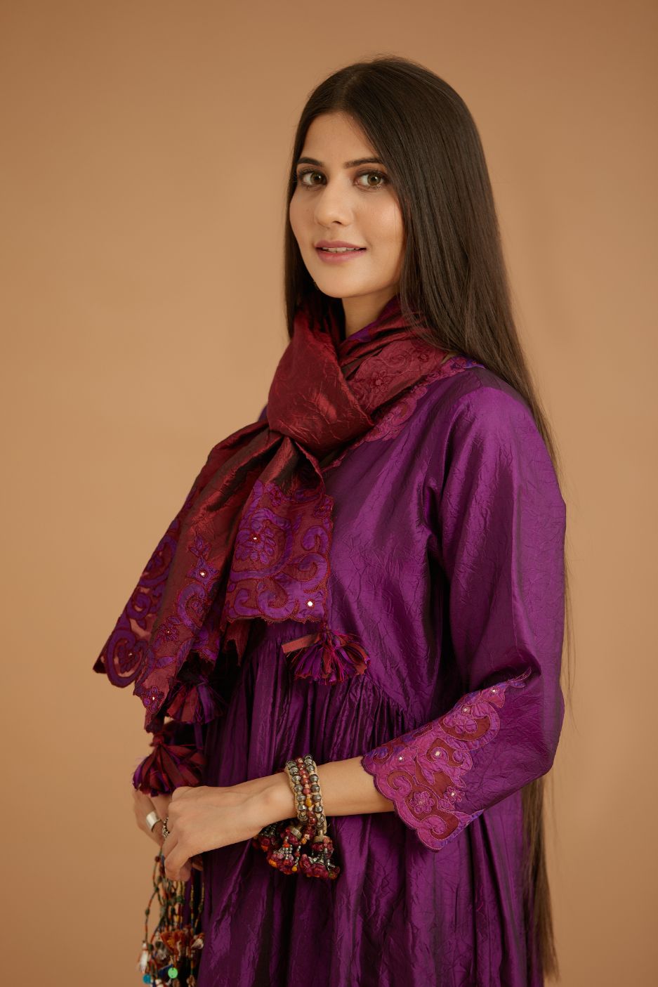 Purple hand crushed silk kurta set with wavy empire waistline and gathers, with silk and organza cutwork embroidery, highlighted with hand attached mirrors.