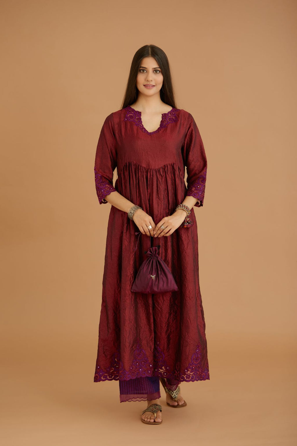 Maroon hand crushed silk kurta set with wavy empire waistline and gathers, with silk and organza cutwork embroidery, highlighted with hand attached mirrors.