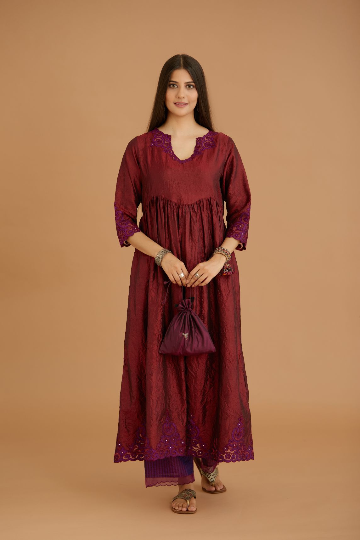 Maroon hand crushed silk kurta set with wavy empire waistline and gathers, with silk and organza cutwork embroidery, highlighted with hand attached mirrors.