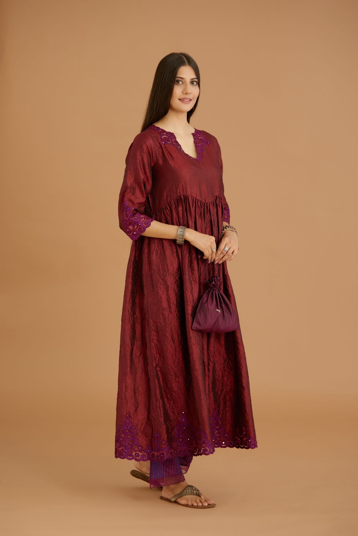 Maroon hand crushed silk kurta set with wavy empire waistline and gathers, with silk and organza cutwork embroidery, highlighted with hand attached mirrors.