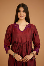 Maroon hand crushed silk kurta set with wavy empire waistline and gathers, with silk and organza cutwork embroidery, highlighted with hand attached mirrors.