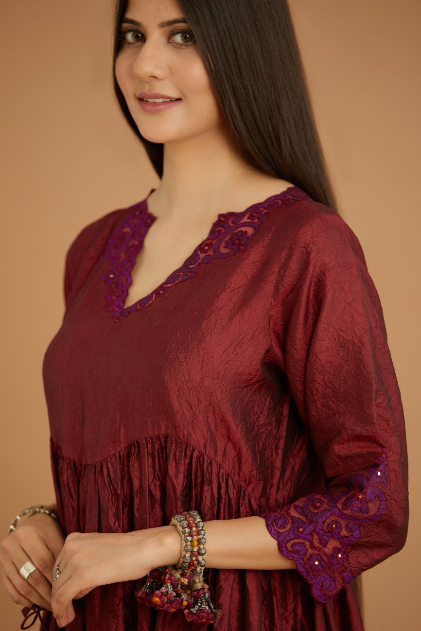 Maroon hand crushed silk kurta set with wavy empire waistline and gathers, with silk and organza cutwork embroidery, highlighted with hand attached mirrors.