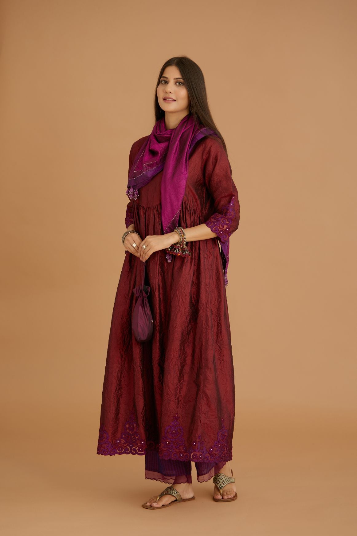 Maroon hand crushed silk kurta set with wavy empire waistline and gathers, with silk and organza cutwork embroidery, highlighted with hand attached mirrors.