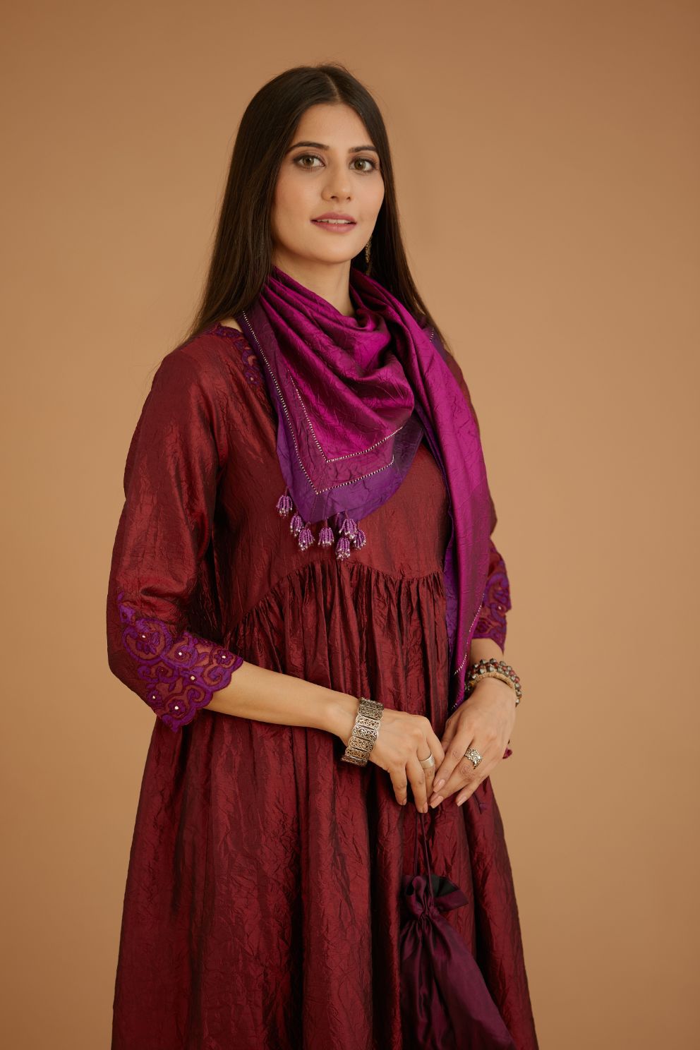 Maroon hand crushed silk kurta set with wavy empire waistline and gathers, with silk and organza cutwork embroidery, highlighted with hand attached mirrors.