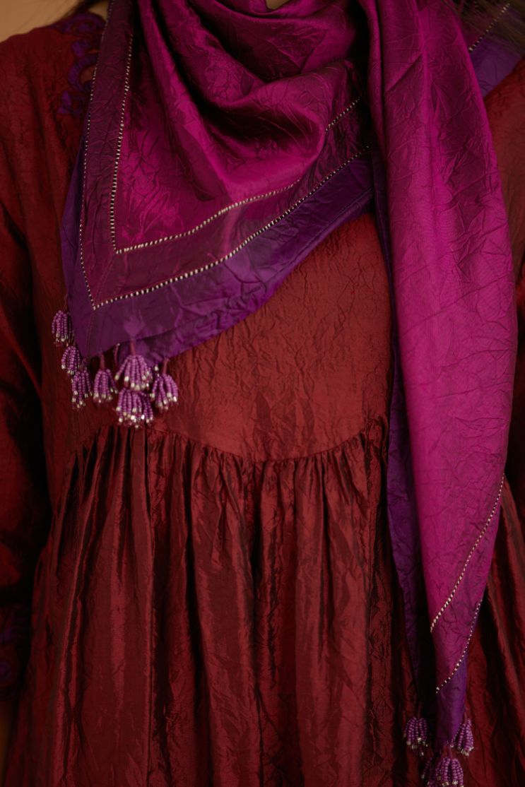 Maroon hand crushed silk kurta set with wavy empire waistline and gathers, with silk and organza cutwork embroidery, highlighted with hand attached mirrors.