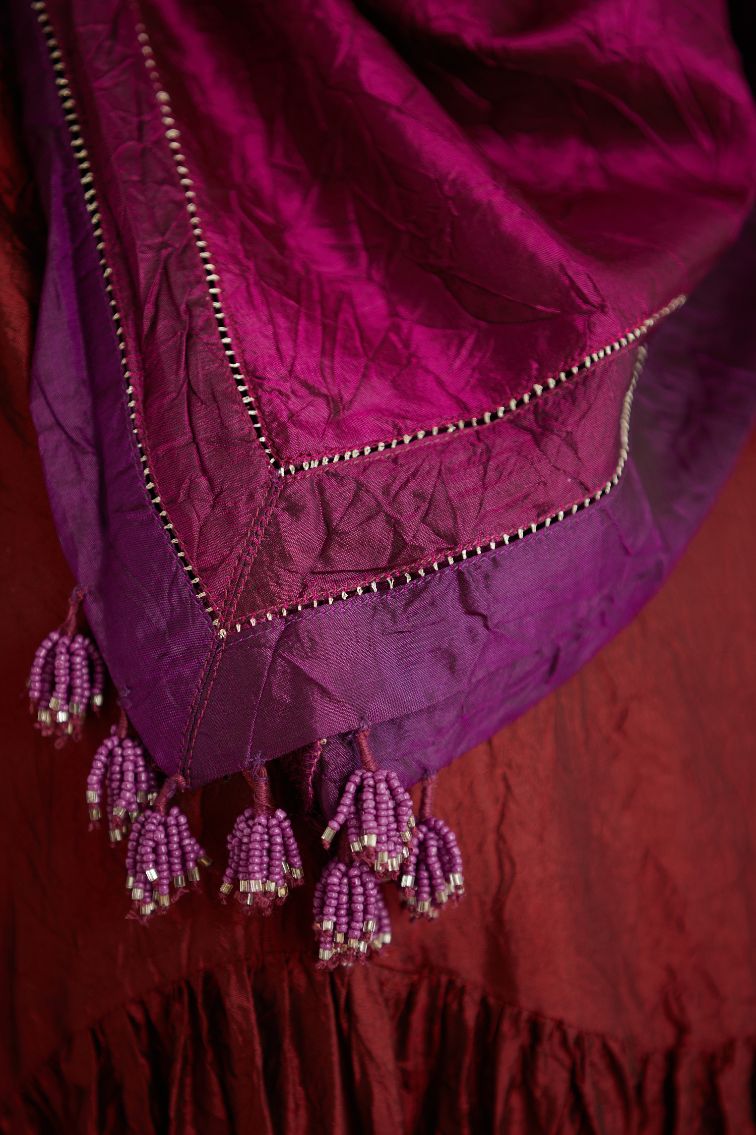 Maroon hand crushed silk kurta set with wavy empire waistline and gathers, with silk and organza cutwork embroidery, highlighted with hand attached mirrors.