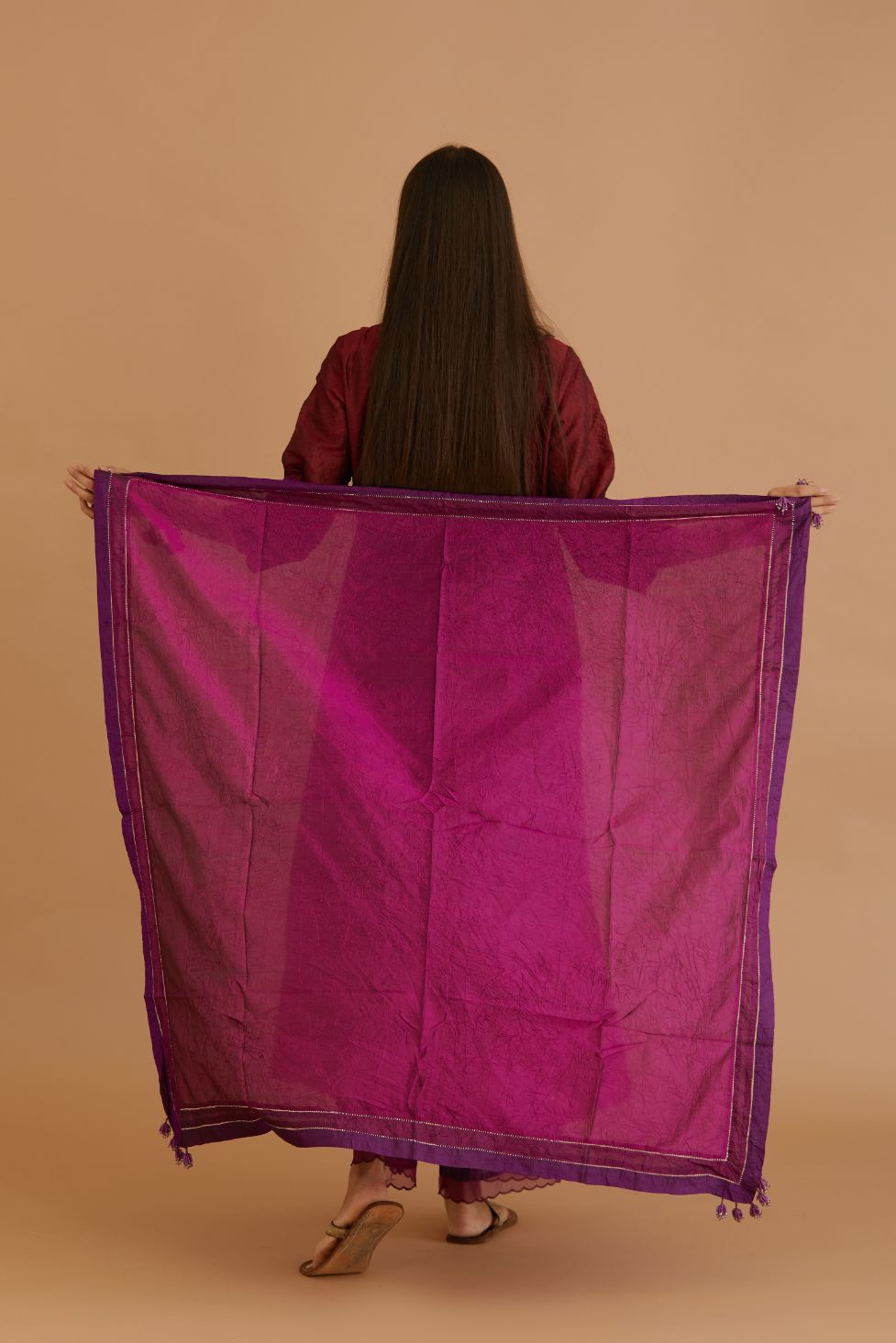 Maroon hand crushed silk kurta set with wavy empire waistline and gathers, with silk and organza cutwork embroidery, highlighted with hand attached mirrors.