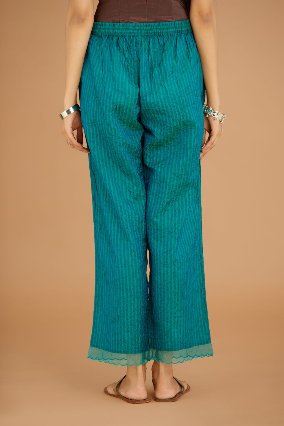 Teal Blue hand crushed silk pants with hand block print fine stripes and organza fabric and embroidery detail at bottom hem.