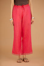 Fuchsia hand crushed silk pants with hand block print fine stripes and organza fabric and embroidery detail at bottom hem.