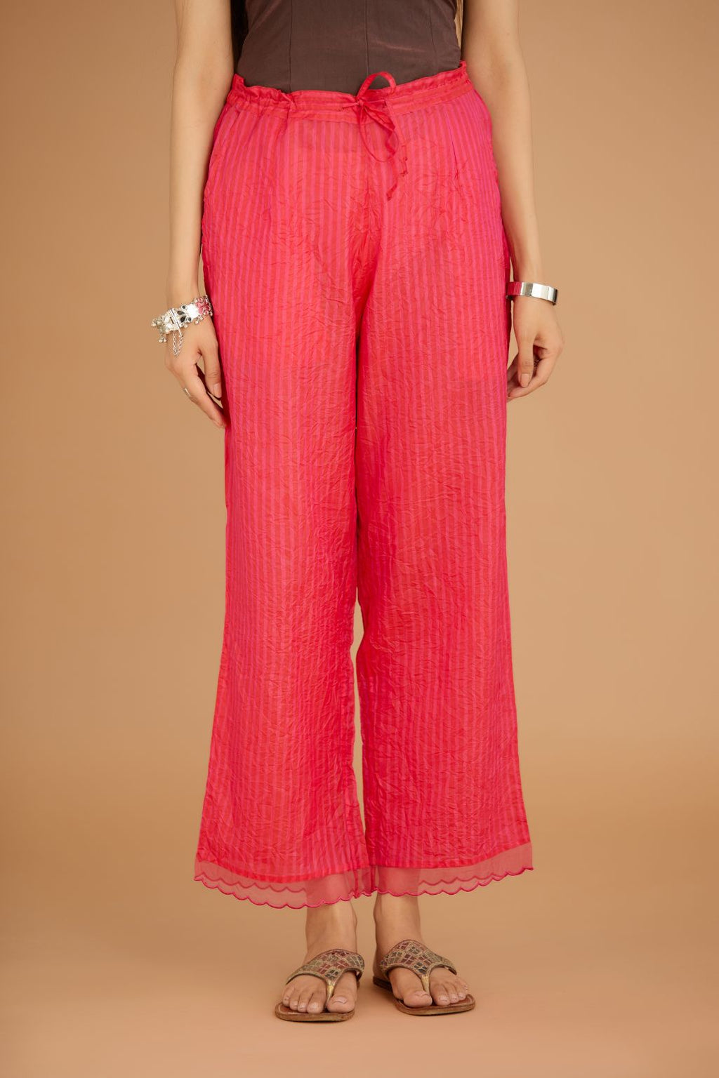 Fuchsia hand crushed silk pants with hand block print fine stripes and organza fabric and embroidery detail at bottom hem.