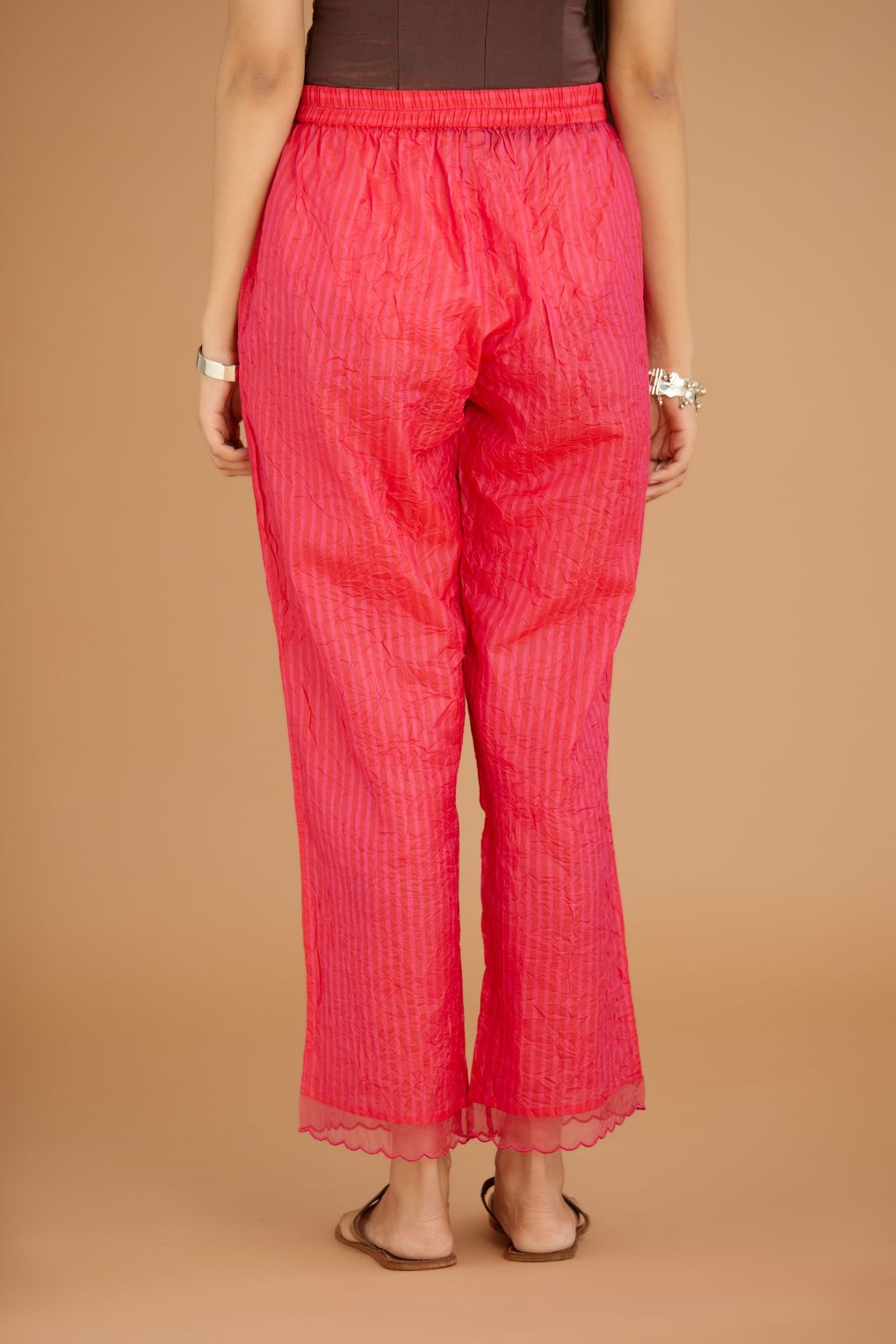 Fuchsia hand crushed silk pants with hand block print fine stripes and organza fabric and embroidery detail at bottom hem.