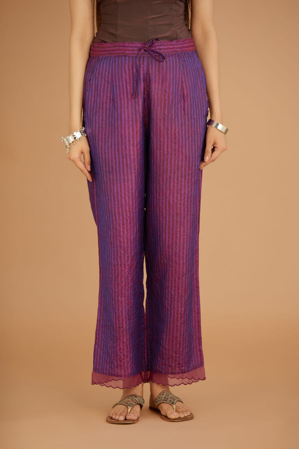 Purple hand crushed silk pants with hand block print fine stripes and organza fabric and embroidery detail at bottom hem.