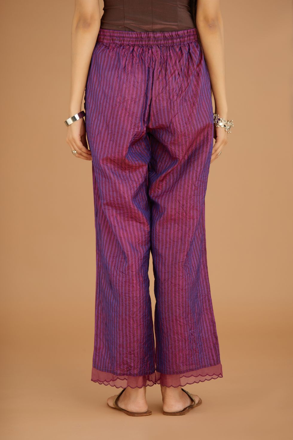 Purple hand crushed silk pants with hand block print fine stripes and organza fabric and embroidery detail at bottom hem.