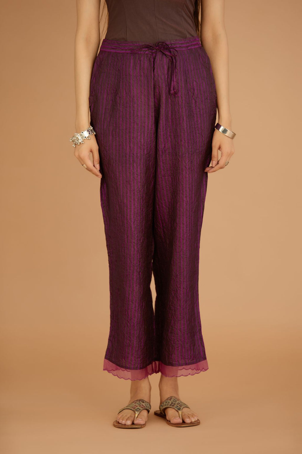 Dark Purple hand crushed silk pants with hand block print fine stripes and organza fabric and embroidery detail at bottom hem.