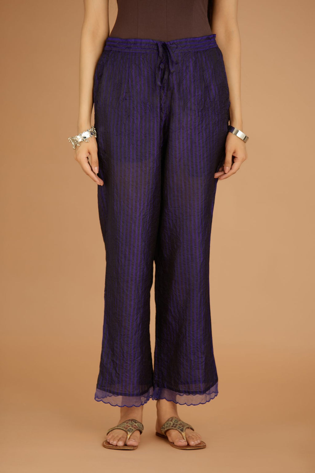 Blue hand crushed silk pants with hand block print fine stripes and organza fabric and embroidery detail at bottom hem.