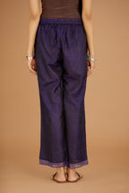 Blue hand crushed silk pants with hand block print fine stripes and organza fabric and embroidery detail at bottom hem.