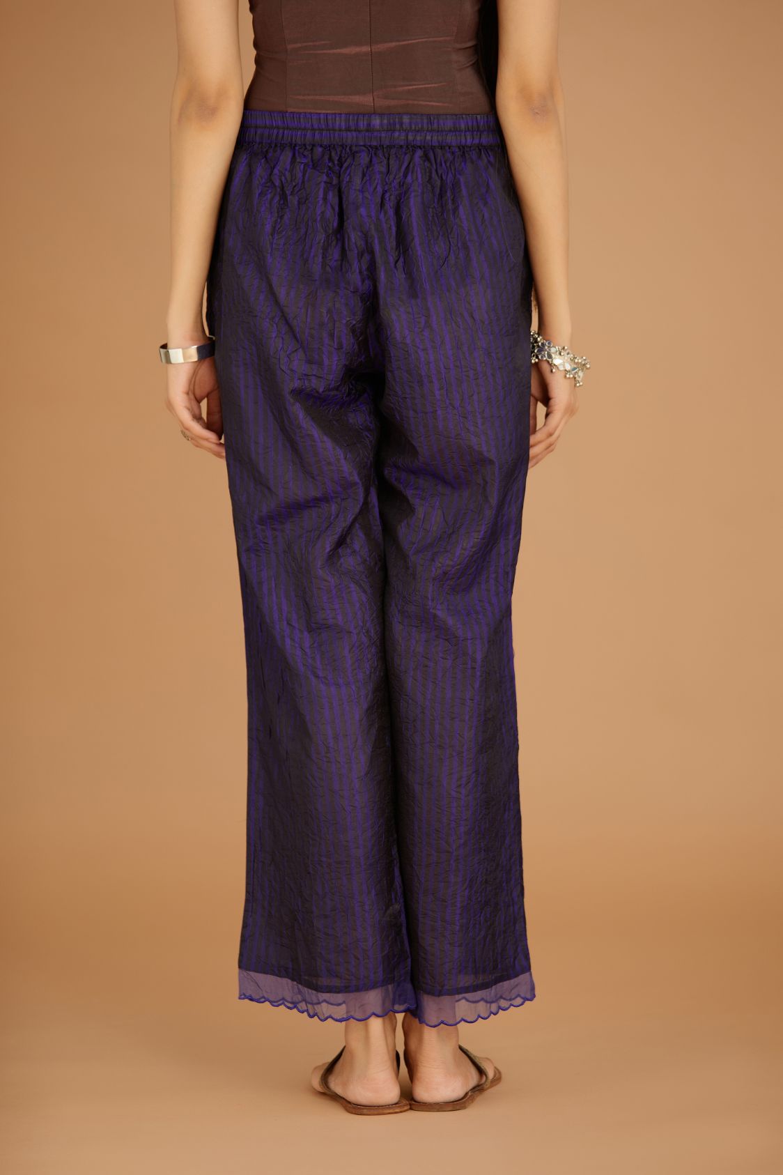 Blue hand crushed silk pants with hand block print fine stripes and organza fabric and embroidery detail at bottom hem.