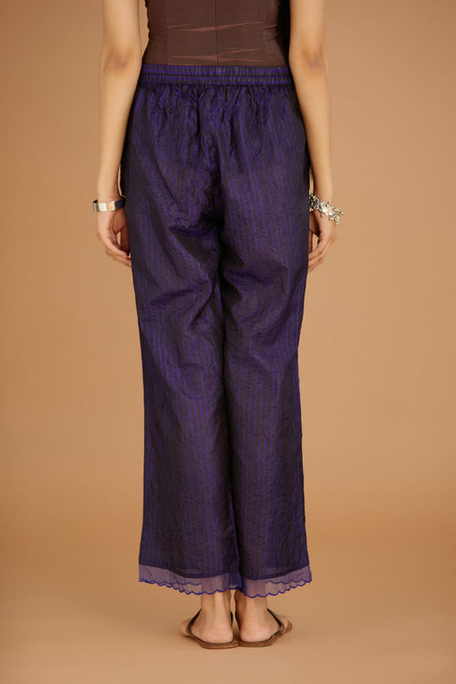 Blue hand crushed silk pants with hand block print fine stripes and organza fabric and embroidery detail at bottom hem.