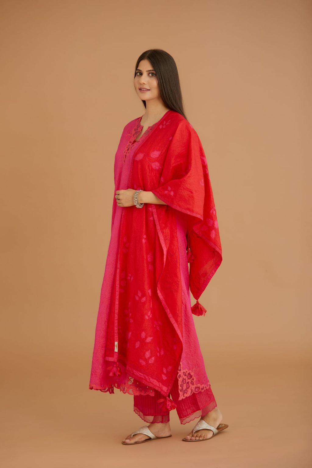 Red hand crushed silk stole with silk fabric applique work and embroidery at edges.