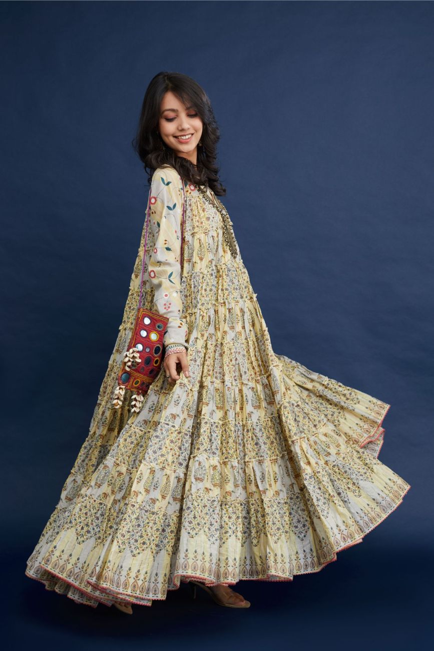 Hand block printed multi-tiered kurta dress set with churi sleeves and multi thread embroidery detailing.