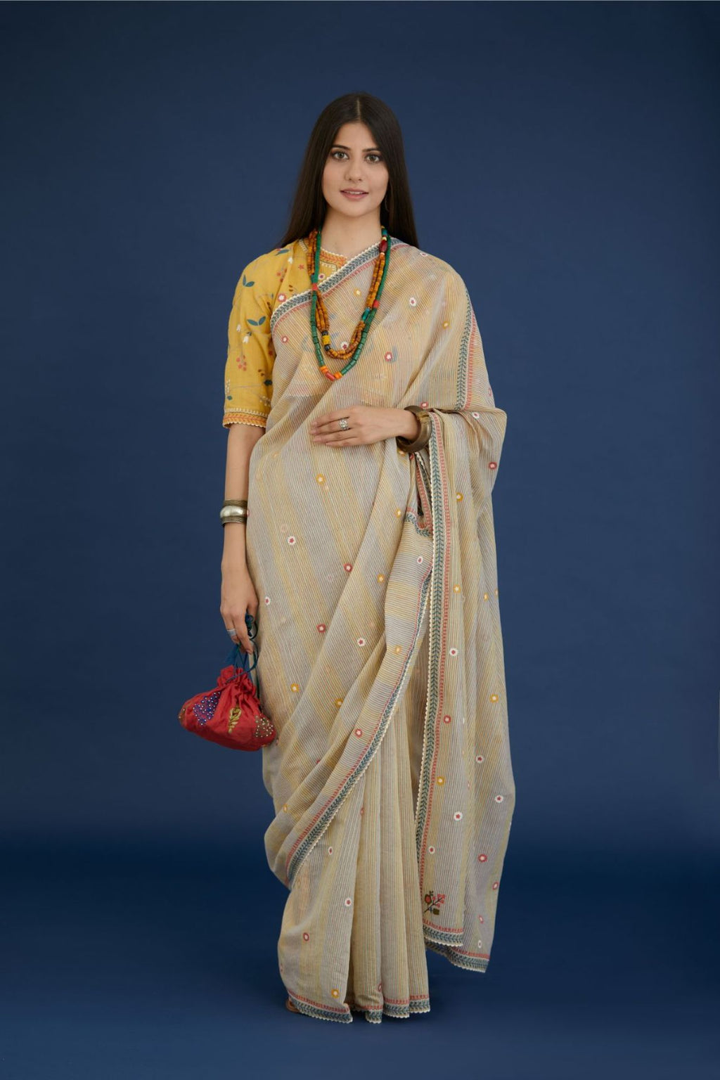 Beige hand block printed cotton Chanderi saree with all-over small floral embroidery. The edges are finished with ric-rac and contrast thread embroidery (Saree+Peticot)