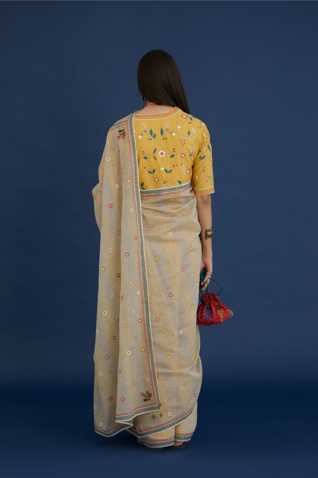 Beige hand block printed cotton Chanderi saree with all-over small floral embroidery. The edges are finished with ric-rac and contrast thread embroidery (Saree+Peticot)