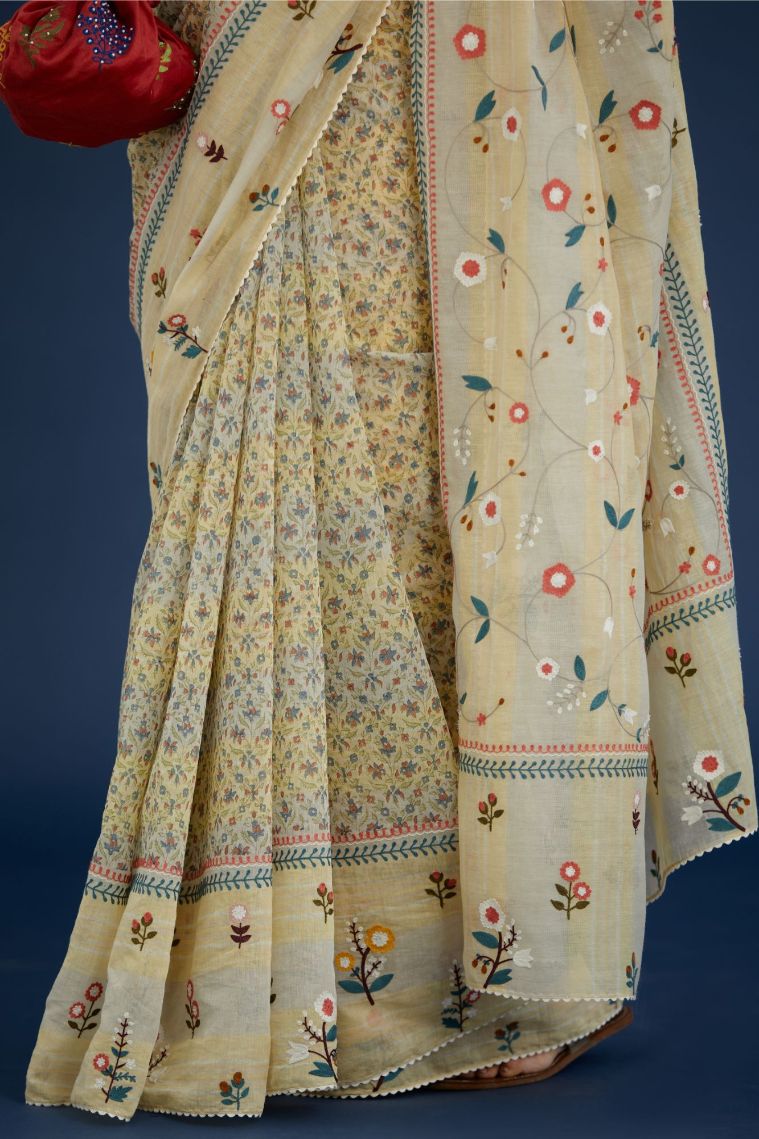 Beige hand block printed cotton Chanderi saree with all-over multi colored thread embroidery and fabric tassels (Saree+Peticot)