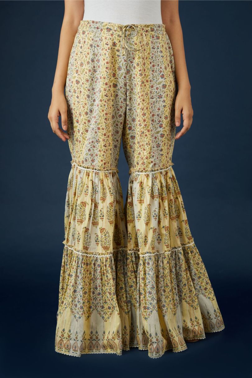 Beige hand block printed cotton farshi, highlighted with ric-rac at all tiers and bottom hem.