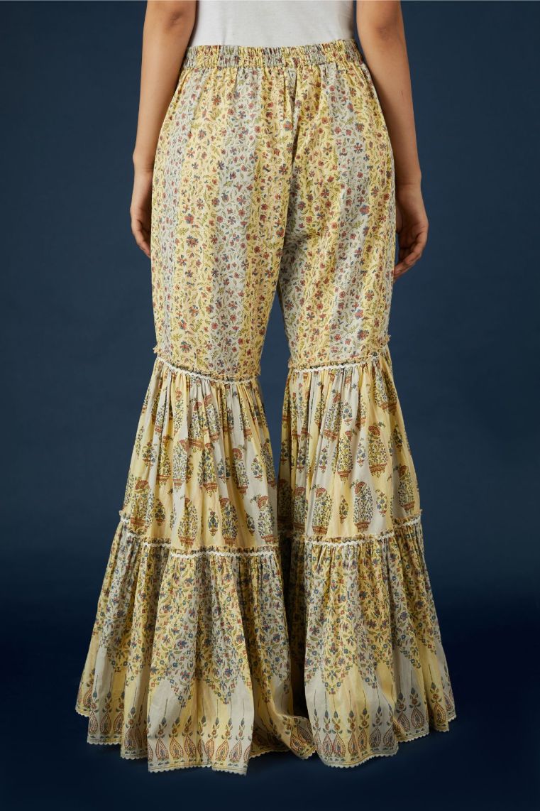 Beige hand block printed cotton farshi, highlighted with ric-rac at all tiers and bottom hem.