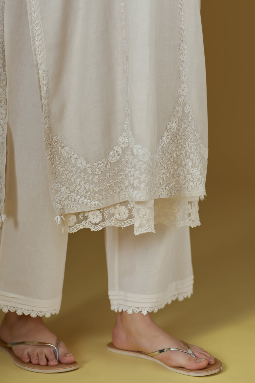 Straight kurta with dori embroidered raised ‘V’ neckline with delicate tassels.