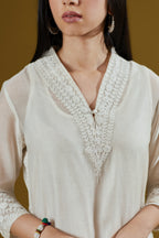 Straight kurta with dori embroidered raised ‘V’ neckline with delicate tassels.