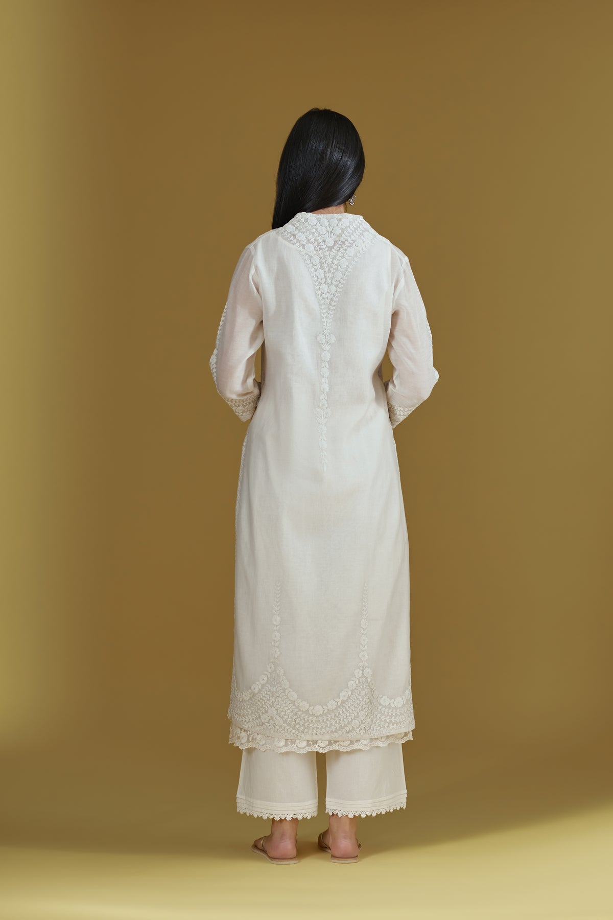 Straight kurta with dori embroidered raised ‘V’ neckline with delicate tassels.