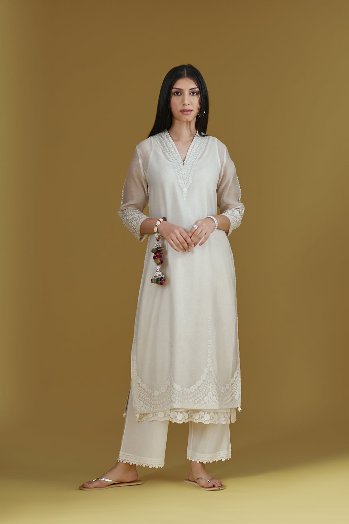 Straight kurta with dori embroidered raised ‘V’ neckline with delicate tassels.
