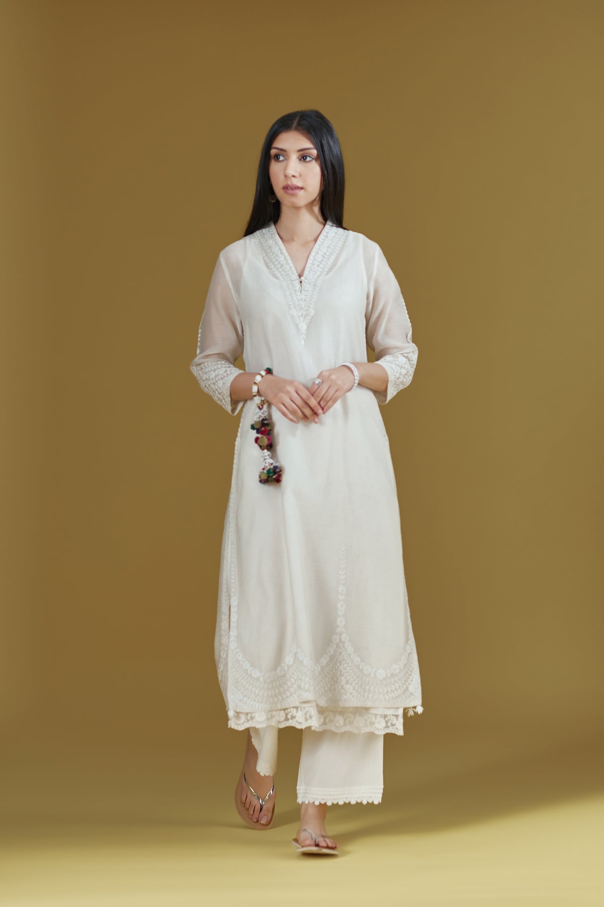 Straight kurta with dori embroidered raised ‘V’ neckline with delicate tassels.