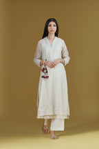 Straight kurta with dori embroidered raised ‘V’ neckline with delicate tassels.