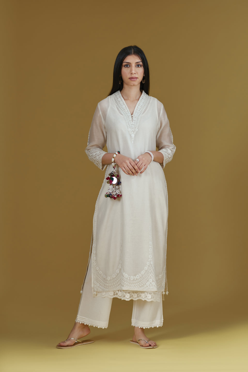 Straight kurta with dori embroidered raised ‘V’ neckline with delicate tassels.