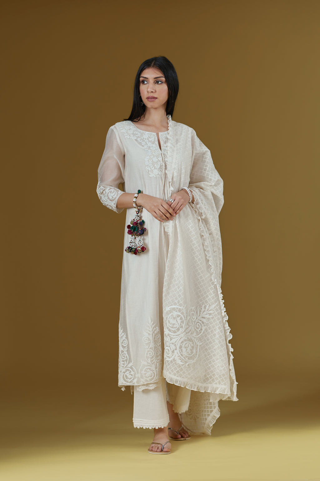 Straight kurta set featured with dori embroidered neck and tying cord, highlighted with beaded tassels