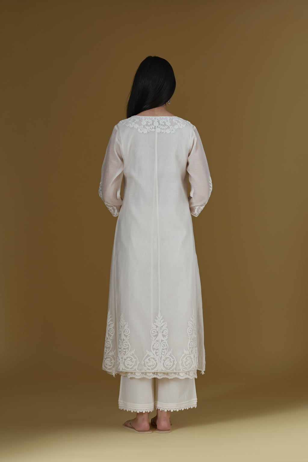 Straight kurta set featured with dori embroidered neck and tying cord, highlighted with beaded tassels