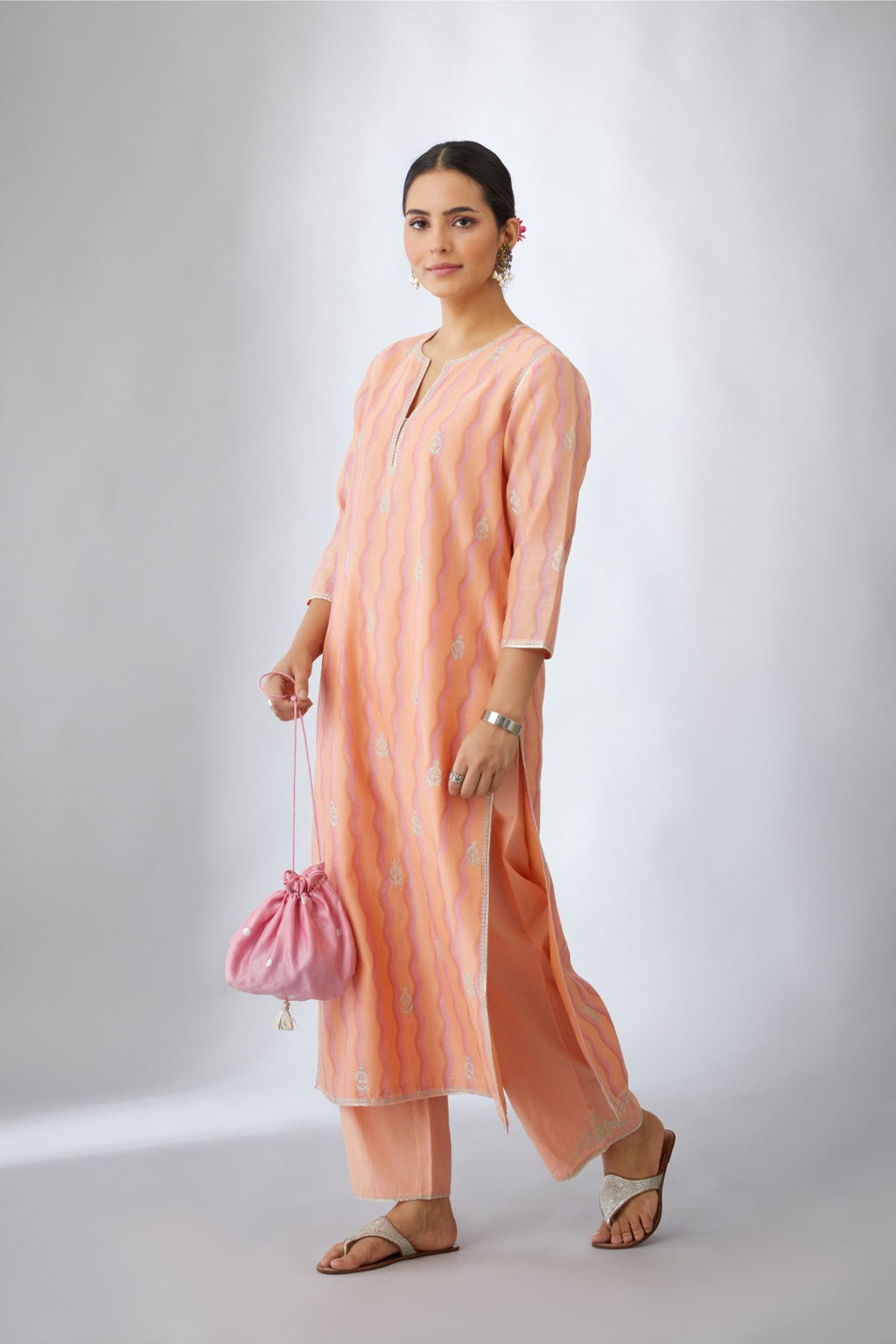 Peach and pink hand block printed silk chanderi kurta set with all-over silver zari embroidery.