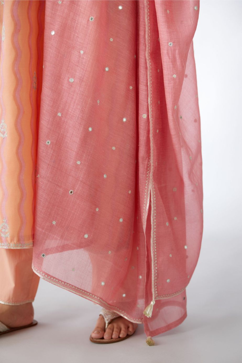 Peach and pink hand block printed silk chanderi kurta set with all-over silver zari embroidery.