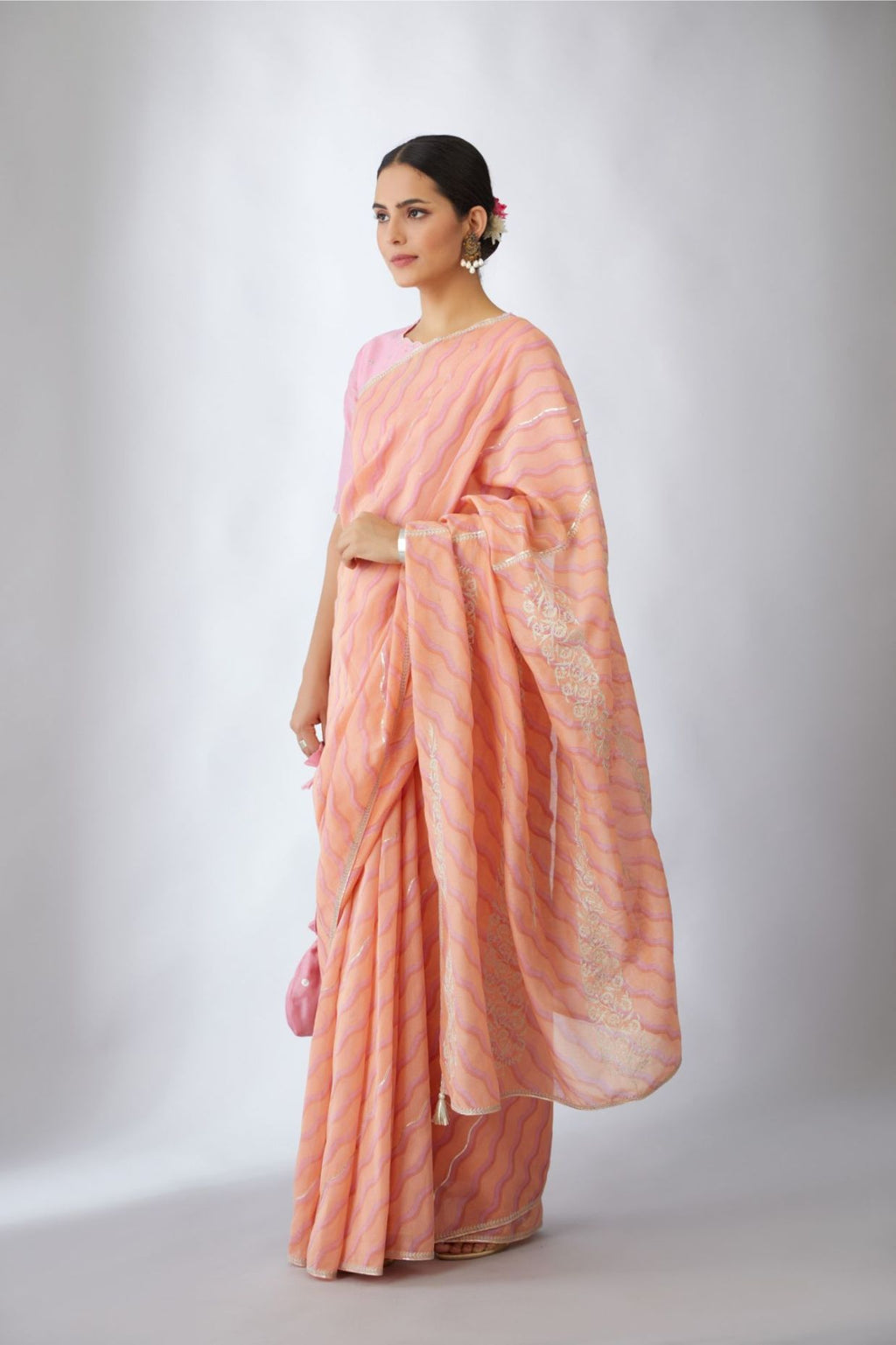 Peach and pink hand block printed silk chanderi saree with all-over Gota and silver zari embroidery.