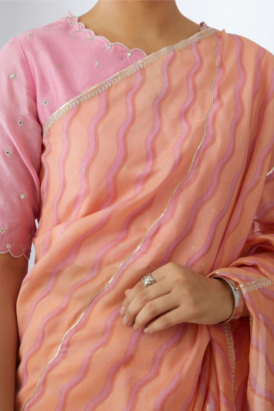Peach and pink hand block printed silk chanderi saree with all-over Gota and silver zari embroidery.