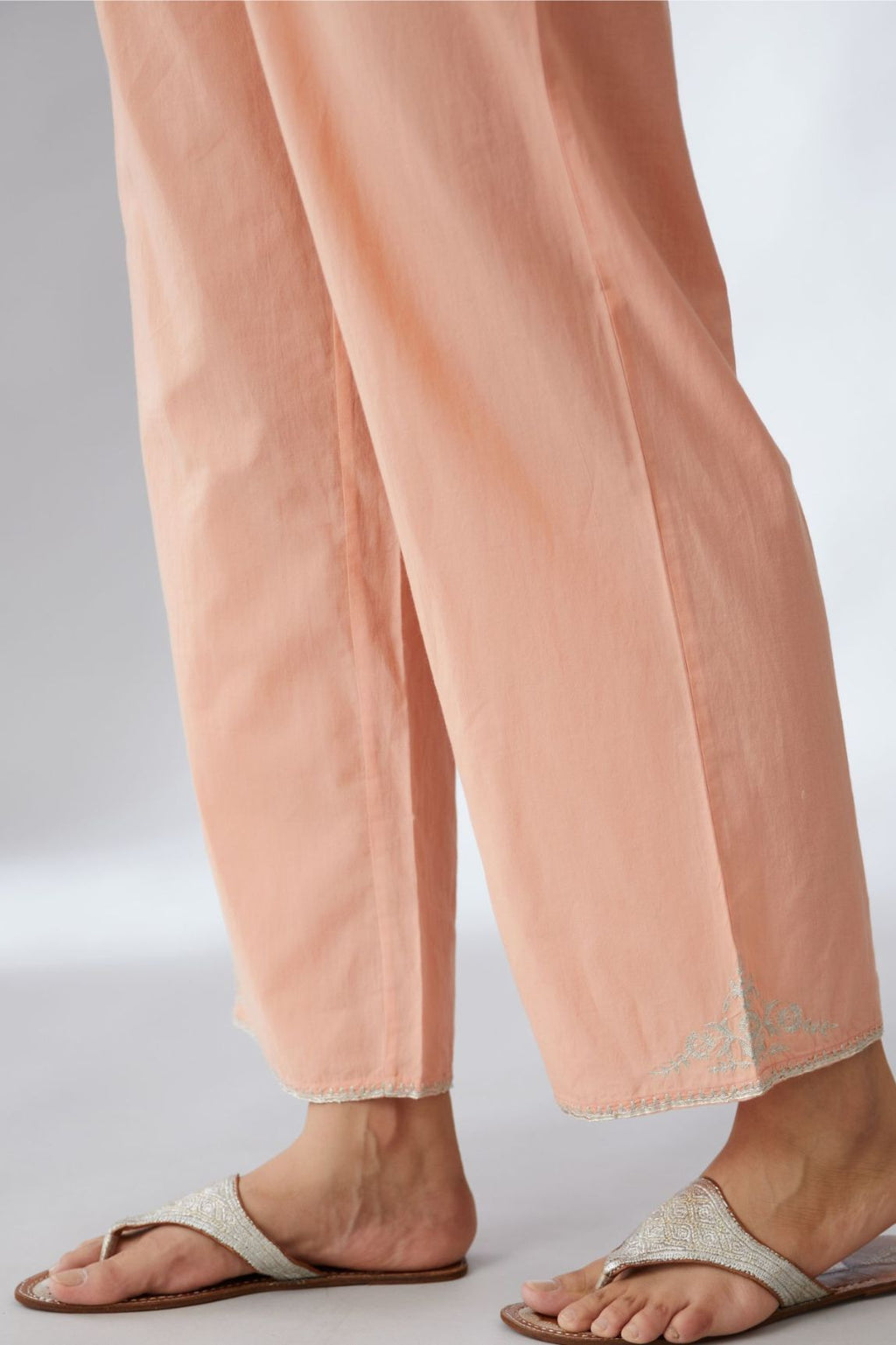 Peach cotton straight pants with silver embroidery detailing at bottom hem (Pants)