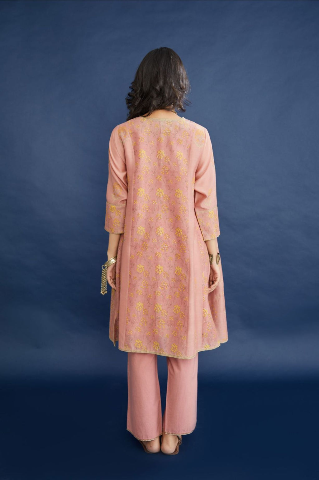 Hand block printed short kalidar kurta set, highlighted with delicate contrast coloured and dull gold zari embroidery.