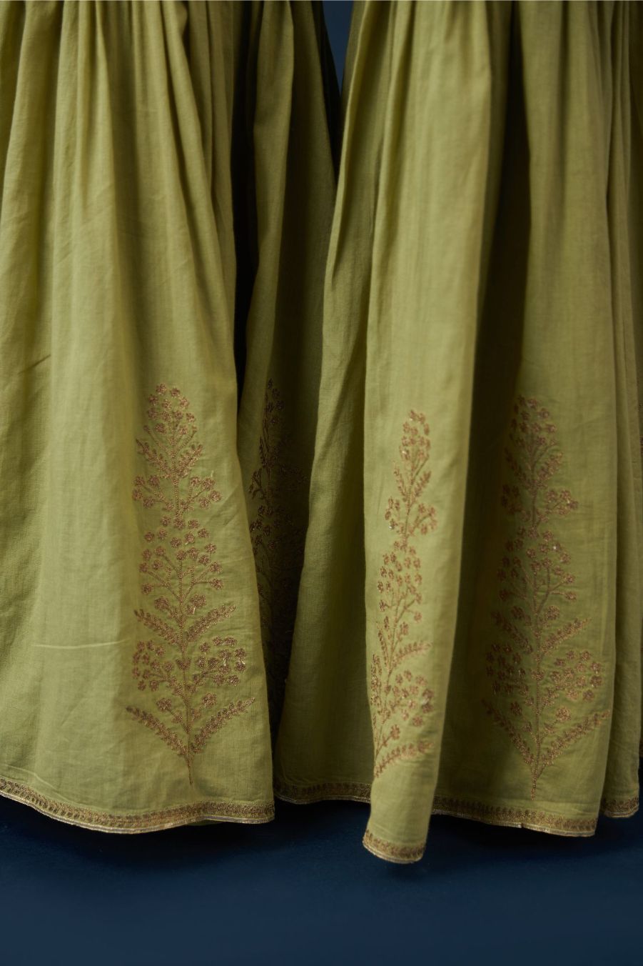 Green farshi with dull gold zari embroidery and gota detailing at hem. (Farshi)