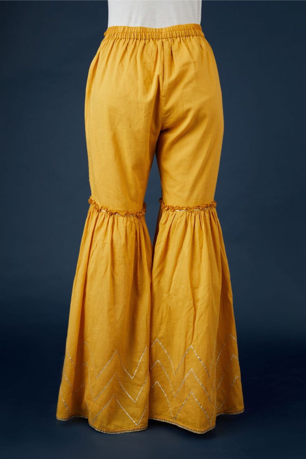 Golden yellow farshi with dull gold gota work and embroidery at hem. (Farshi)