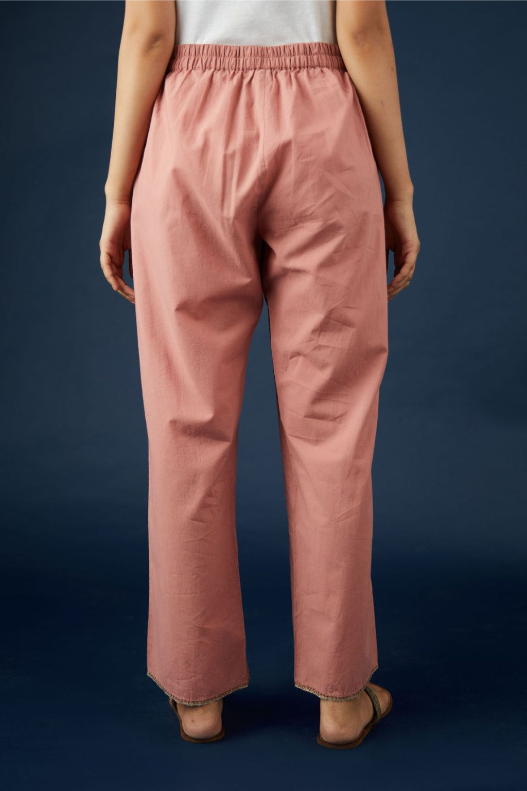 Dusty rose cotton straight pants with dull gold zari embroidery detailing at bottom hem. (Pants)