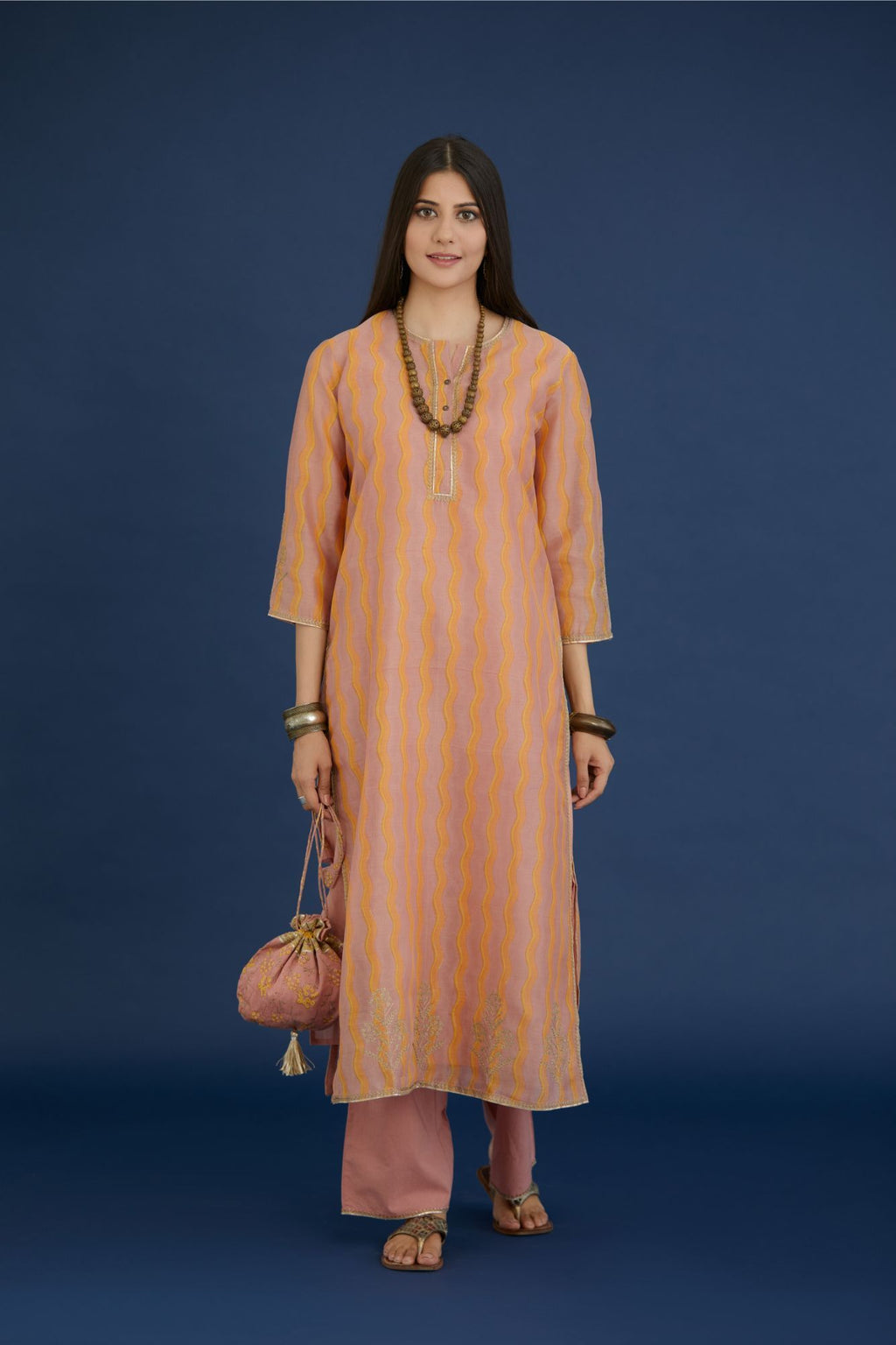 Dusty rose and yellow hand block printed straight kurta set, highlighted with dull gold zari embroidery.