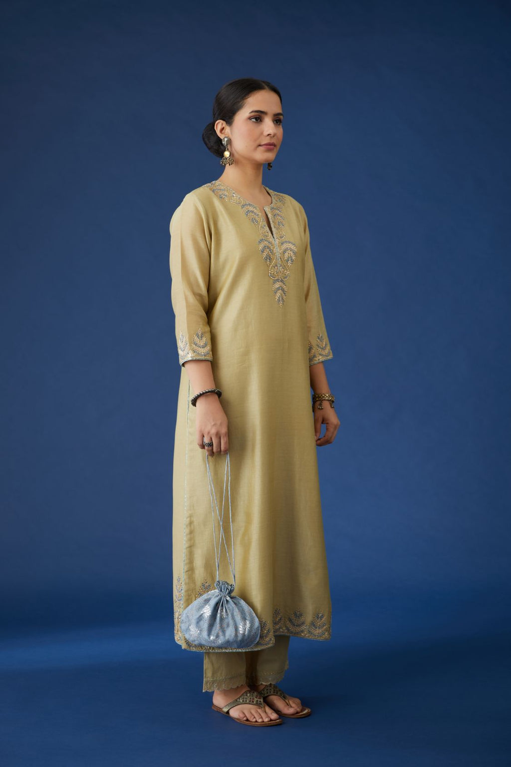 Olive silk chanderi straight kurta set with contrast silk thread and gota embroidery at neck and hem, highlighted with bead work.
